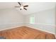 Bright bedroom featuring hardwood floors, vaulted ceilings, and a modern ceiling fan at 2090 Blackberry Ln, Auburn, GA 30011
