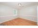 Cozy bedroom featuring hardwood floors, natural light and neutral paint at 2090 Blackberry Ln, Auburn, GA 30011