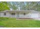 Charming single-story home with a covered porch and well-maintained front yard at 2090 Blackberry Ln, Auburn, GA 30011