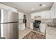 Bright kitchen showcasing stainless steel appliances, white cabinetry, and granite countertops at 2090 Blackberry Ln, Auburn, GA 30011