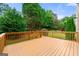 The home features a wooden back deck with a lush green lawn and mature trees at 917 Saints Ct, Marietta, GA 30068