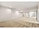 Finished basement space with neutral carpeting and multiple doorways at 917 Saints Ct, Marietta, GA 30068