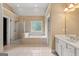 This bathroom features a tiled floor, glass shower, large tub, and double vanity with sink at 917 Saints Ct, Marietta, GA 30068