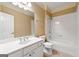 Bathroom featuring a single sink vanity, toilet, and tub with white tiling at 917 Saints Ct, Marietta, GA 30068