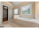 Bathroom boasts a large soaking tub with a separate glass enclosed shower at 917 Saints Ct, Marietta, GA 30068