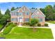 Stunning two-story brick home with a well-manicured lawn and lush landscaping at 917 Saints Ct, Marietta, GA 30068