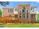 Back of a brick home featuring a deck, brickwork, and large arched windows at 917 Saints Ct, Marietta, GA 30068