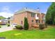 Charming brick home featuring a well-maintained lawn, attached garage, and backyard deck, perfect for outdoor entertaining at 917 Saints Ct, Marietta, GA 30068