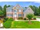 A beautiful brick two-story home with a well manicured lawn and mature trees at 917 Saints Ct, Marietta, GA 30068