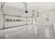 Spacious two-car garage with ample lighting and epoxy flooring provides space for vehicles and storage at 917 Saints Ct, Marietta, GA 30068