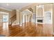 Open-concept living room with hardwood floors, fireplace, and built-in bookshelves at 917 Saints Ct, Marietta, GA 30068