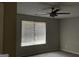 Neutral bedroom featuring a modern ceiling fan and a window with horizontal blinds at 135 Green Commons Dr, Covington, GA 30016