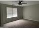 Neutral bedroom featuring a modern ceiling fan and a window with horizontal blinds at 135 Green Commons Dr, Covington, GA 30016