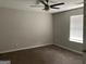 Standard bedroom with neutral walls and carpet, highlighted by a modern ceiling fan at 135 Green Commons Dr, Covington, GA 30016