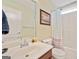 Bathroom boasts a single sink, framed mirror, shower with curtain, and toilet at 1979 Spivey Village Dr, Jonesboro, GA 30236