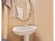 Cozy half bath features a white pedestal sink and neutral wall color at 1979 Spivey Village Dr, Jonesboro, GA 30236