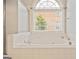 Soaking tub underneath window in bathroom; shower stall on left side at 1979 Spivey Village Dr, Jonesboro, GA 30236
