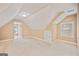 This room features angled ceilings, two windows, and neutral carpeting at 1979 Spivey Village Dr, Jonesboro, GA 30236