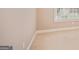 This bedroom features neutral carpeting and paint, base molding, and a window at 1979 Spivey Village Dr, Jonesboro, GA 30236