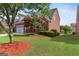 Charming two-story brick home with a well-manicured lawn and mature tree at 1979 Spivey Village Dr, Jonesboro, GA 30236