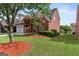 Charming two-story brick home with a well-manicured lawn and mature tree at 1979 Spivey Village Dr, Jonesboro, GA 30236