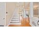 Bright foyer with hardwood floors, staircase, and view into the upstairs hallway at 1979 Spivey Village Dr, Jonesboro, GA 30236