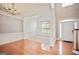 Bright foyer with hardwood floors, staircase, and views into the formal dining room at 1979 Spivey Village Dr, Jonesboro, GA 30236