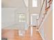 Bright foyer with hardwood floors, staircase, and views into the formal living room at 1979 Spivey Village Dr, Jonesboro, GA 30236