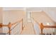 Second story hallway boasts a white railing, beige carpet, and doors leading to other rooms at 1979 Spivey Village Dr, Jonesboro, GA 30236