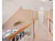 Hallway has a white railing, beige carpet, and an open view down to the living area below at 1979 Spivey Village Dr, Jonesboro, GA 30236