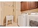 Laundry room features stainless steel washer, dryer, and utility sink at 1979 Spivey Village Dr, Jonesboro, GA 30236