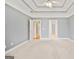 Spacious bedroom featuring a trey ceiling and neutral carpeting at 1979 Spivey Village Dr, Jonesboro, GA 30236
