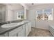 Bathroom with a double sink vanity, large mirror and natural light at 11893 Aukerman Way, Hampton, GA 30228