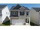 Charming two-story home featuring a two-car garage and a well-manicured lawn in a Gathering-friendly neighborhood at 11893 Aukerman Way, Hampton, GA 30228