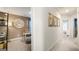 Hallway view into the study with decorative clock, chair, and shelving at 11893 Aukerman Way, Hampton, GA 30228