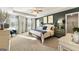 Spacious main bedroom featuring tray ceilings, lots of natural light, and an ensuite bathroom with a walk-in closet at 11893 Aukerman Way, Hampton, GA 30228