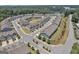 An aerial view of a townhome community with manicured lawns, sidewalks, trees and green spaces in a nice neighborhood at 2060 Lanier Harbor Pt, Buford, GA 30518