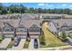 An aerial view of a two story townhome community with well manicured lawns and sidewalks in a green neighborhood at 2060 Lanier Harbor Pt, Buford, GA 30518