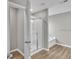 A spacious bathroom features a glass shower, a garden tub, and vinyl flooring at 2060 Lanier Harbor Pt, Buford, GA 30518