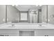 Bathroom featuring a vanity with double sinks, a large mirror, and bright lighting at 2060 Lanier Harbor Pt, Buford, GA 30518