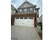 Two car garage with brick facade and driveway at 2060 Lanier Harbor Pt, Buford, GA 30518