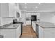 Spacious kitchen featuring granite countertops, white cabinets, stainless steel appliances and hardwood floors at 2060 Lanier Harbor Pt, Buford, GA 30518