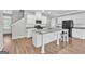 Bright kitchen featuring a kitchen island with white cabinets and granite countertops at 2060 Lanier Harbor Pt, Buford, GA 30518