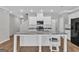 Bright eat-in kitchen with white cabinetry, granite countertops, stainless steel appliances, and center island at 2060 Lanier Harbor Pt, Buford, GA 30518