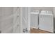 Laundry room with washer, dryer, and wire shelving for storage at 2060 Lanier Harbor Pt, Buford, GA 30518