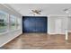 Bright, open living room features hardwood floors and an accent wall at 2060 Lanier Harbor Pt, Buford, GA 30518