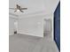 Spacious bedroom featuring a tray ceiling with a ceiling fan, gray carpet and an ensuite bathroom at 2060 Lanier Harbor Pt, Buford, GA 30518