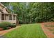 Well-maintained backyard with lush green grass and mature trees, providing a serene outdoor space at 770 Spalding Heights Dr, Atlanta, GA 30350