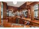 Wet bar in the basement with beautiful wood finishes, cabinetry and a wine rack at 770 Spalding Heights Dr, Atlanta, GA 30350