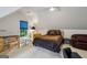 Large bedroom with neutral walls, seating, and desk at 770 Spalding Heights Dr, Atlanta, GA 30350
